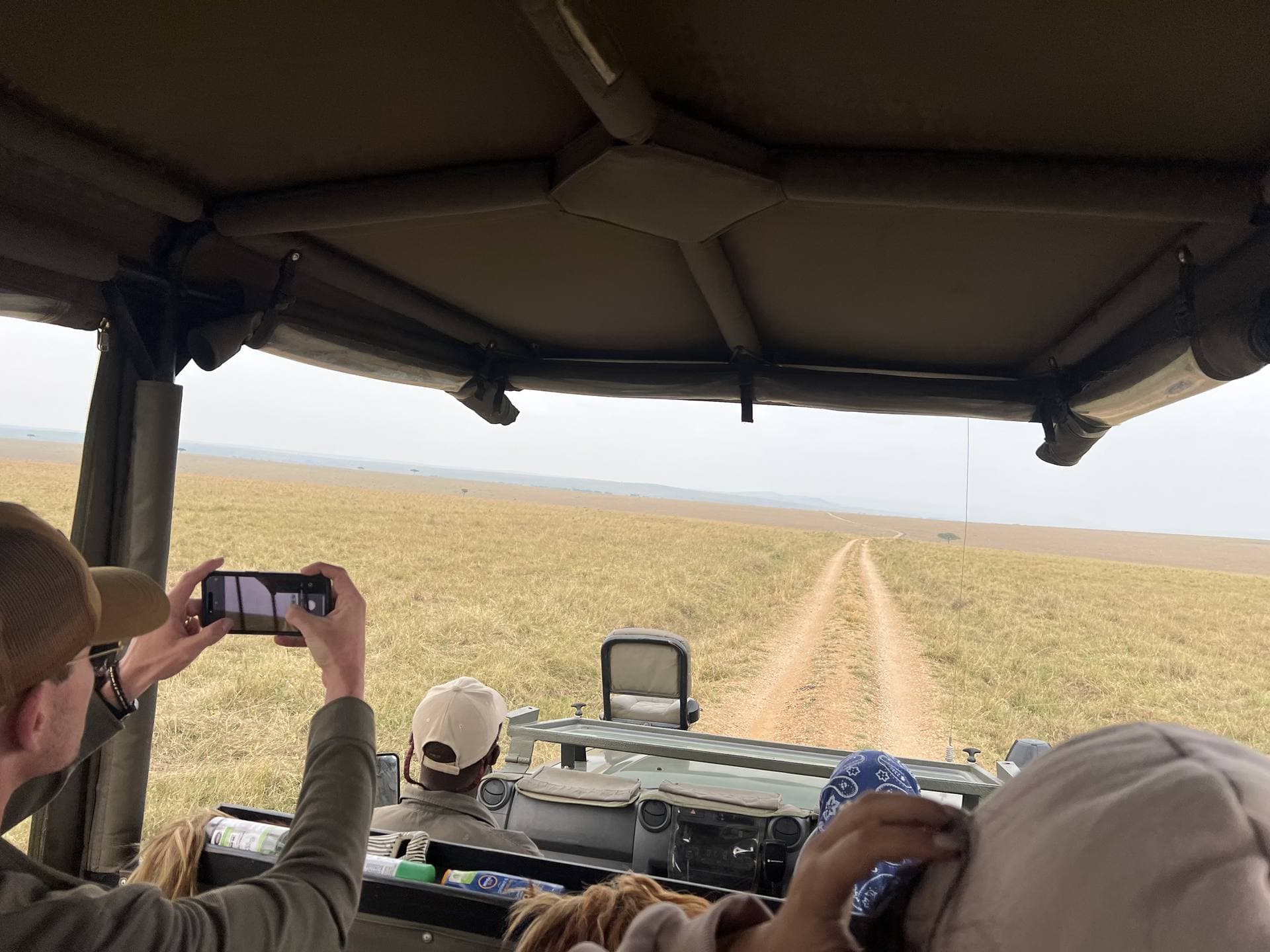 Guests enjoying a view from the pop-up roof of a Land Cruiser