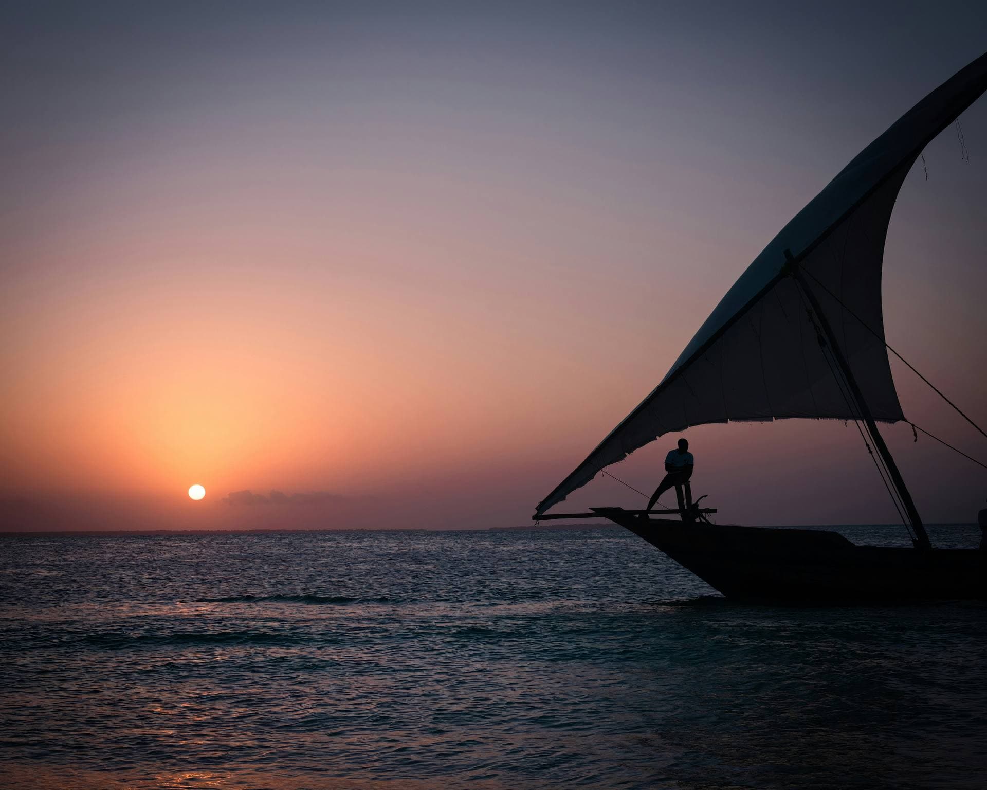 Dhow sailing past Zanzibar at sunset