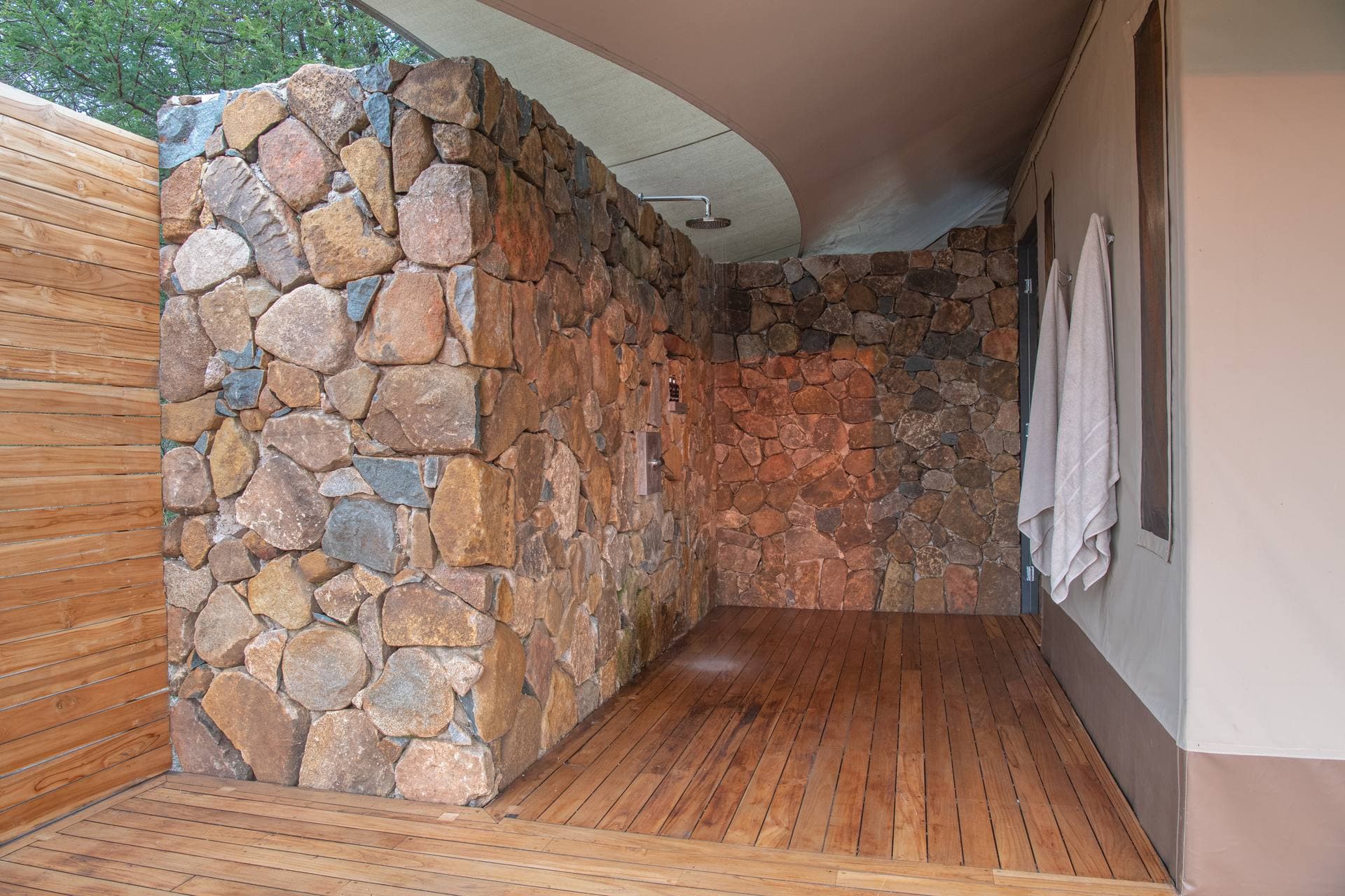 Private ensuite bush bathroom with a bucket shower